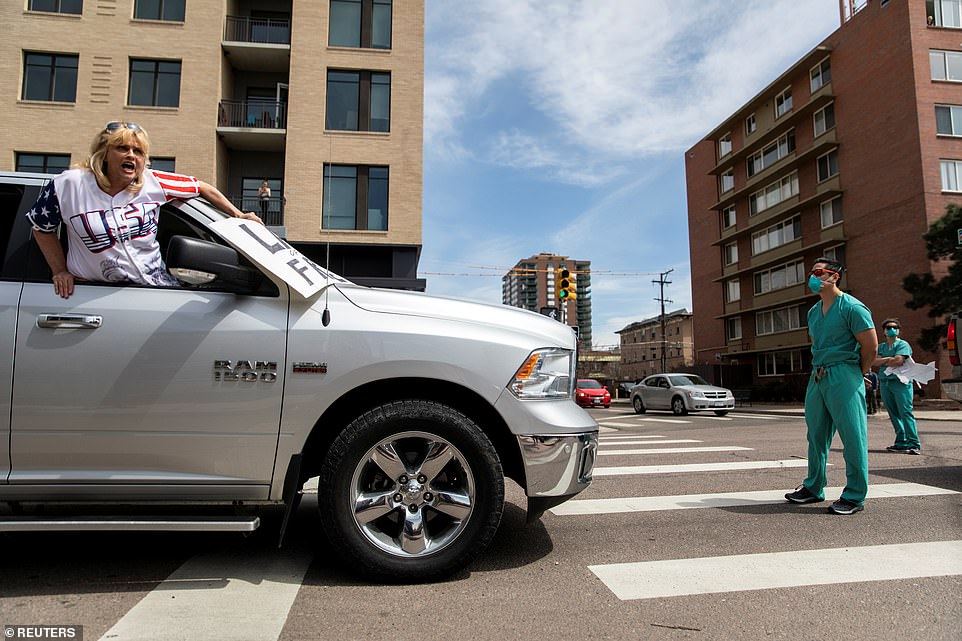 Photographs captured the nurses standing in front of a number of vehicles staring back at the drivers with their arms crossed, refusing to move under a cacophony of horns and heckles