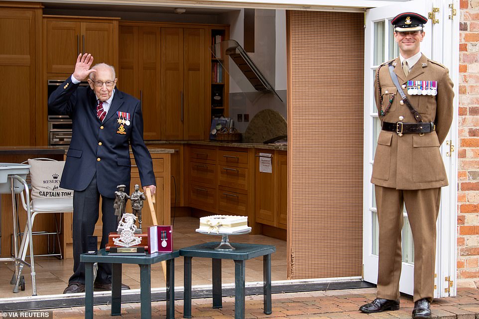 Lieutenant Colonel Thomas Miller presented the beloved war veteran with the medal - though they maintained social distancing - and Colonel Tom was given gifts and a cake to mark his centenary