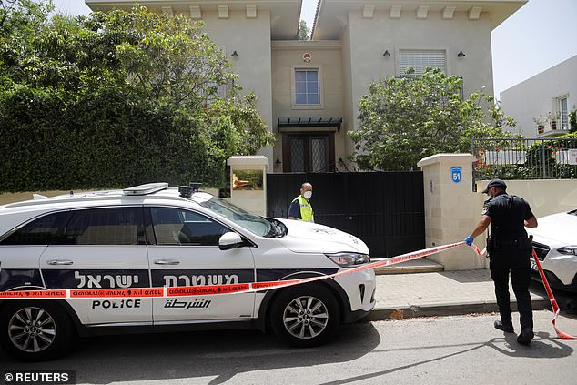 An Israeli policeman cordons off an area near the house of China