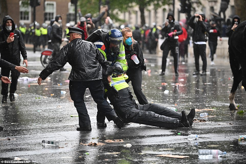 The injured officer is seen being pulled off the street by two other officers and a protestor. Met Police have confirmed she is recovering in hospital