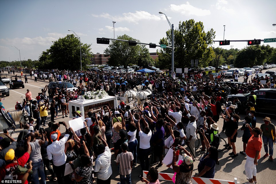 Powerful images showed hundreds raising their fists as the horse-drawn carriage headed to the Houston Memorial Gardens cemetery in Pearland, Texas