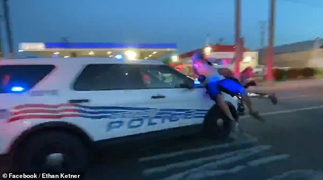 This is the horrifying moment a police car charges into a crowd of screaming protesters in Detroit before speeding off with demonstrators still clinging to the hood