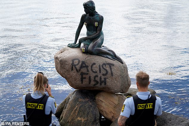 A graffiti reading "Racist Fish" is seen on a statue of "The Little Mermaid" in Copenhagen, Denmark July 3