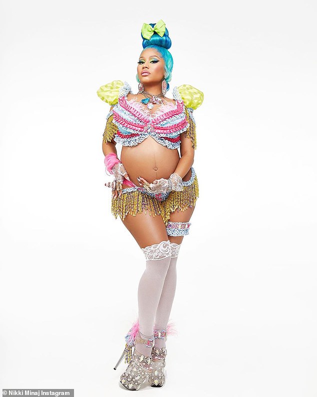 Belly proud: There was also a second photo with a blue wig and another decorated bikini. In this one, she added white thigh high stockings