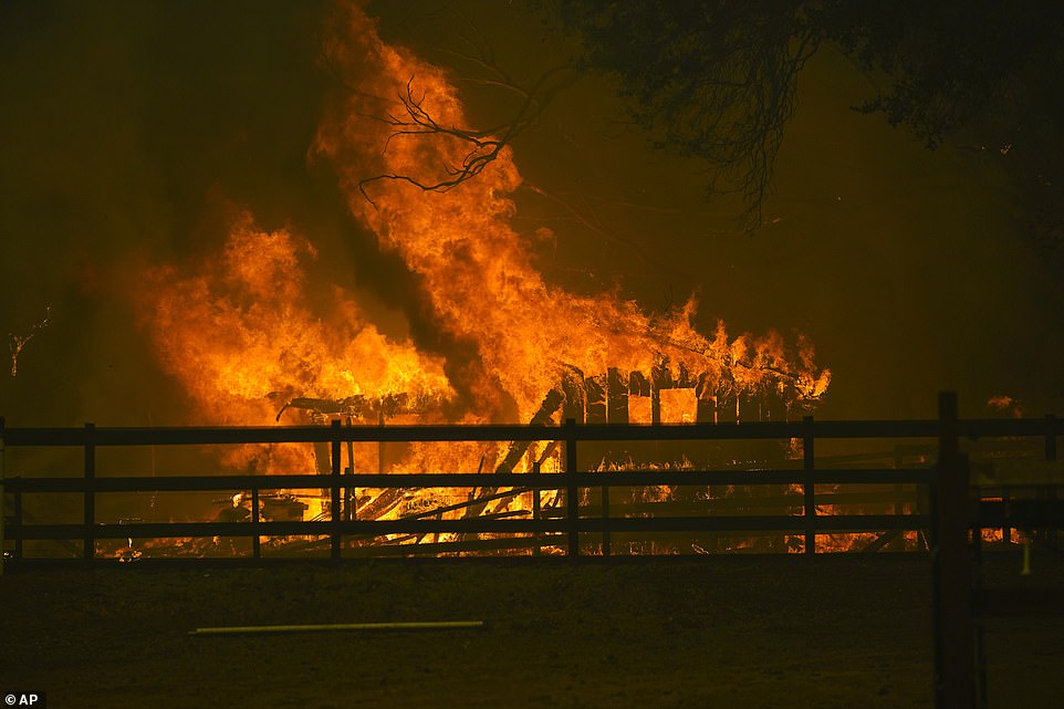 A structure is damaged by the CZU August Lightning Complex Fire in Santa Cruz County on Thursday. Evacuation orders were issued across the county Thursday evening as it was revealed there is zero percent containment on the fires in this zone