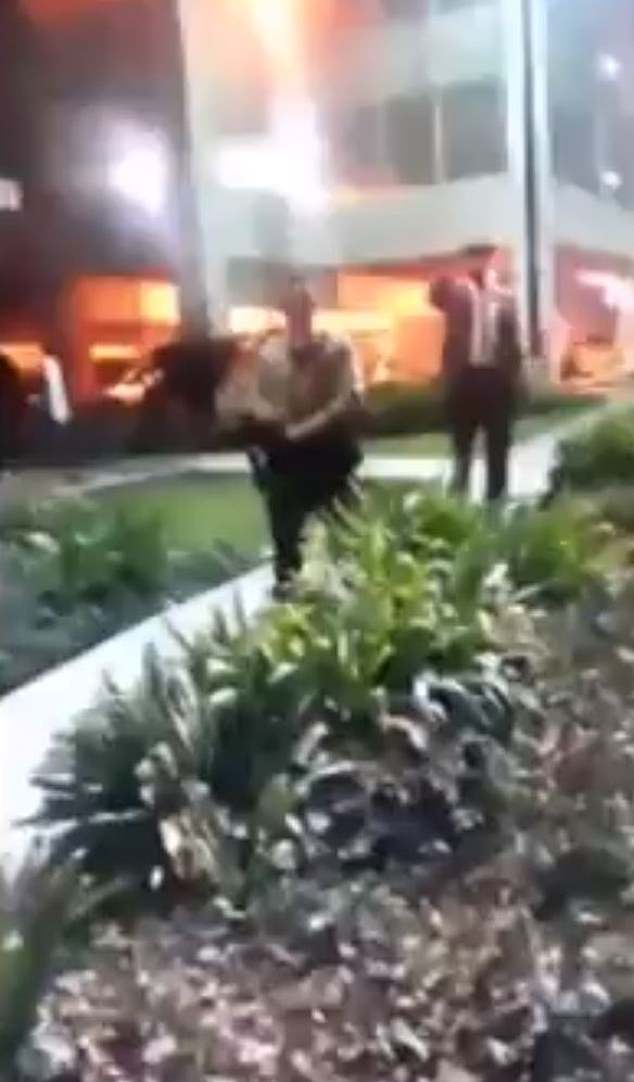 Protesters blocked the entrance to the hospital where the two deputies ambushed in a shooting Saturday were fighting for their lives, chanting: 