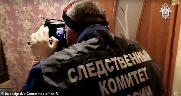 Investigators can be seen working at the scene of the crime. Local media reported that Molchanov managed to keep his past convictions secret from Saprunova