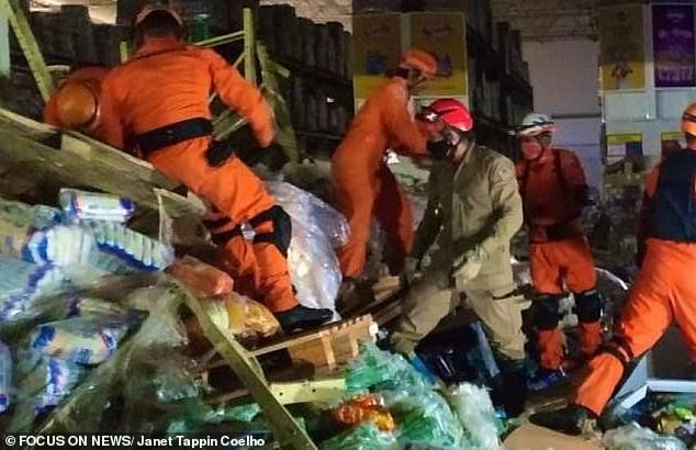 Rescue workers searching through the piles of supermarket goods after the accident