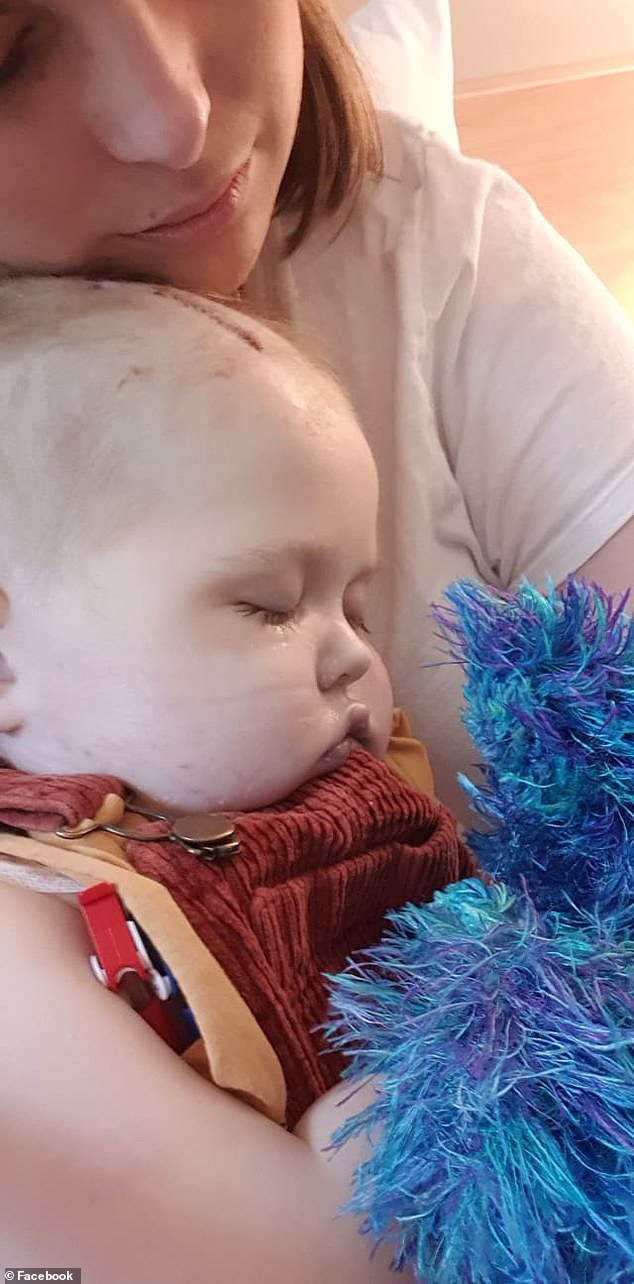 Thomas in the arms of his mother, Leah Collins. Leah tried desperately to help her son