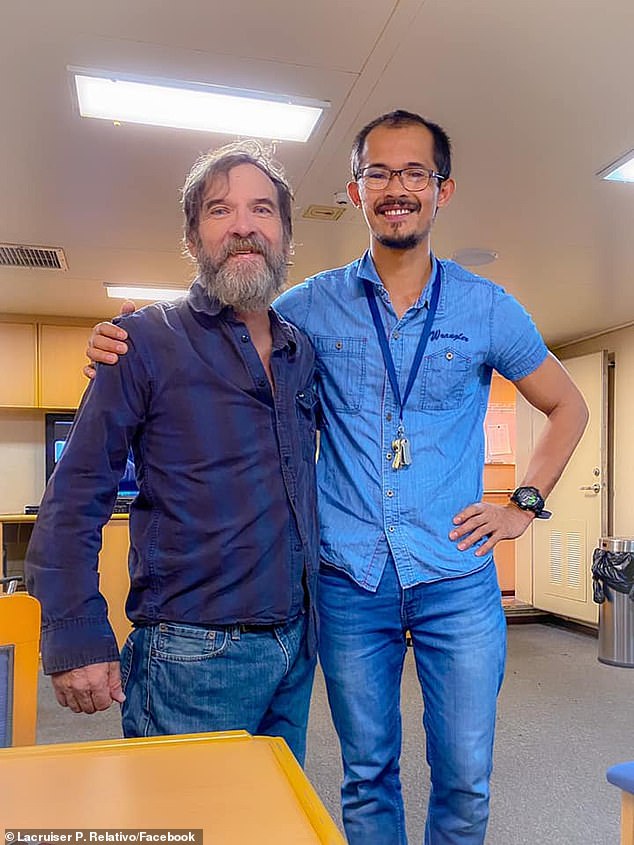 Lacruiser P. Relativo, a merchant mariner, right, who was onboard the Angeles container ship took a photo with Bee and gave him fresh clothes to wear