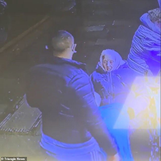 The woman in the wheelchair looks on as the thug takes the money and leaves the scene