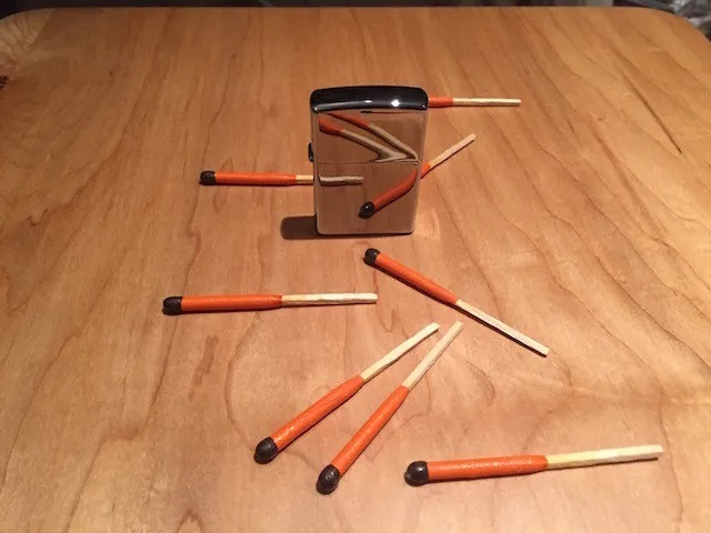 matches and shiny lighter table