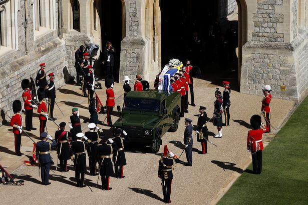 The Duke of Edinburgh’s coffin, covered with His Royal Highness’s Personal Standard is carried to the purpose built Land Rover during the funeral of Prince Philip, Duke of Edinburgh at Windsor Castle on April 17, 2021