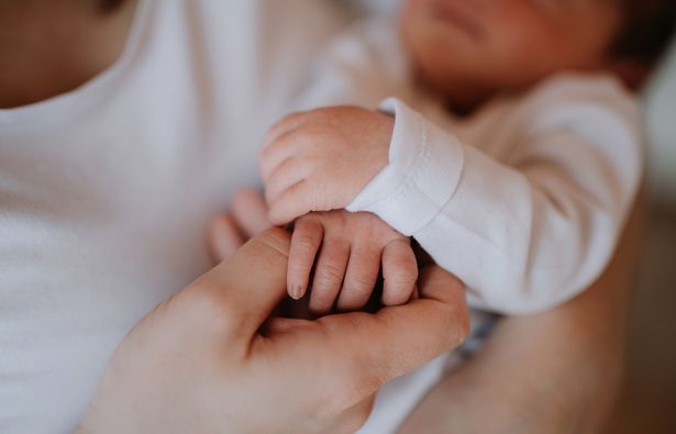 A mum holding a newborn baby