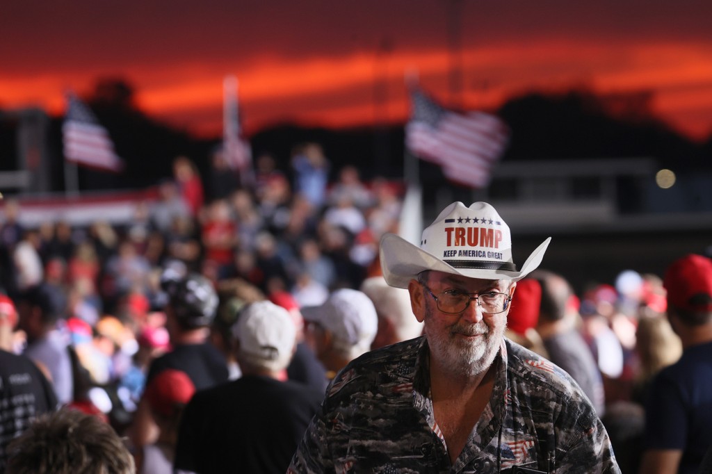 A supporter dons a “Trump Keep America Great” cowboy hat during former President Donald Trump’s rally at the Iowa State Fairgrounds.