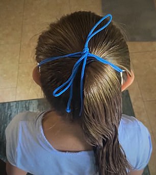 Sophia Steele, seven, was forced by teachers to wear a mask that was tied to her head, her father says. She has Down syndrome and is nonverbal, and he believed she was exempt