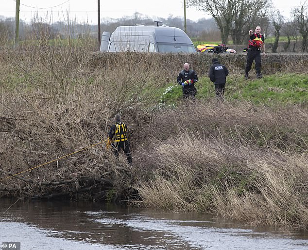 A police diving team at the River Wyre near St Michael