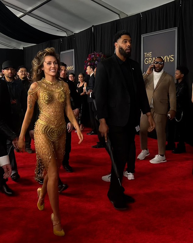 Miley Cyrus bodyguard video sparks wild theories star is in danger after Grammys red carpet walk | Daily Mail Online